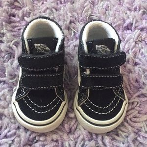 Black and white high top vans